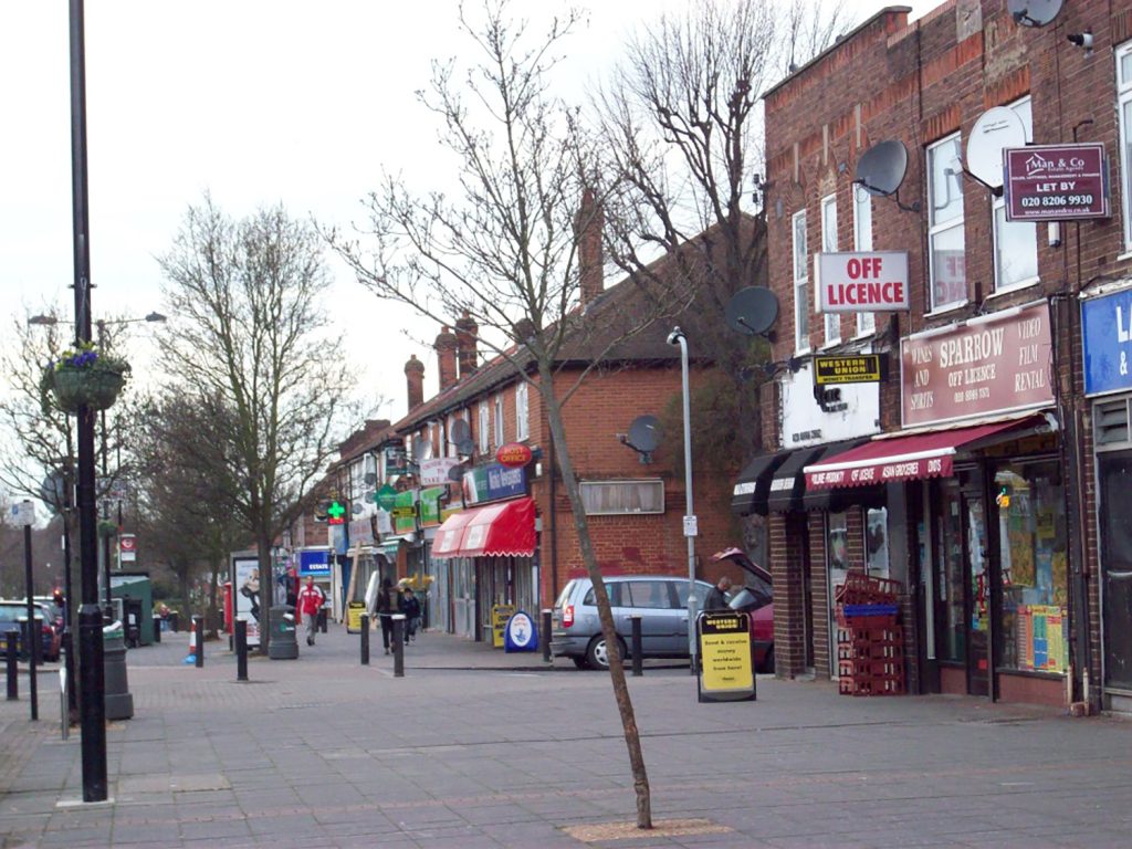 A street in a city with a lot of shops.