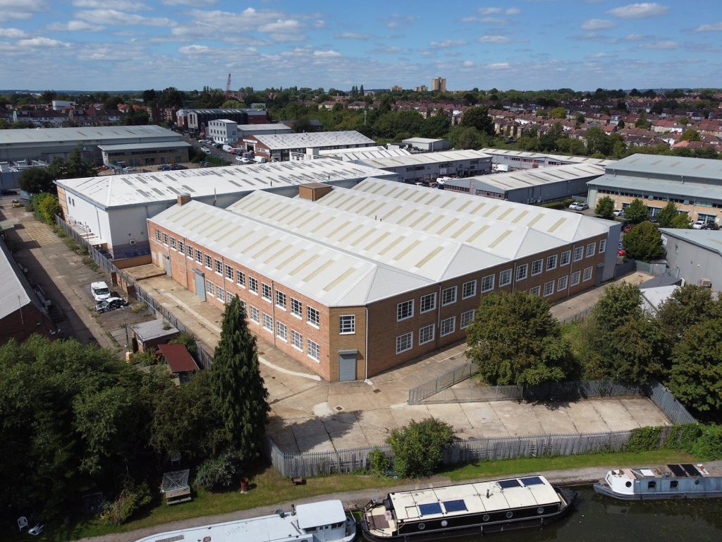 An aerial view of an industrial building near a river.