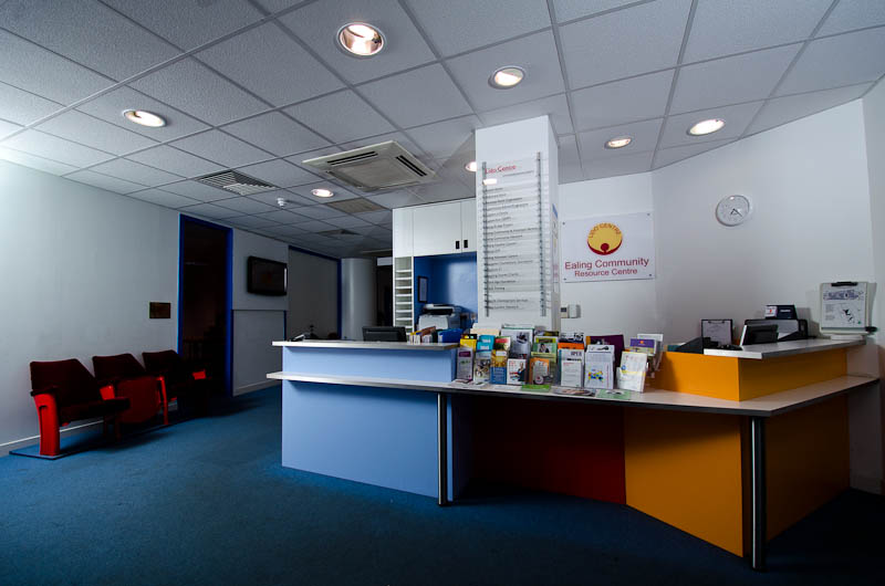 A brightly colored office with a desk and chairs.