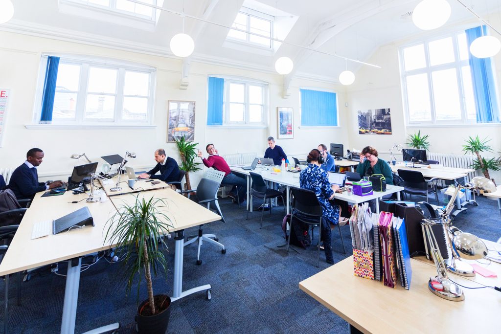 A large open office with people working at desks.